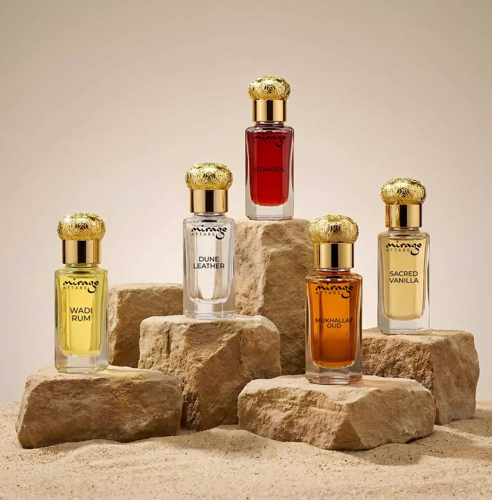 Mirage Attars luxury attar bottles with gold caps staged on stone against desert sand
